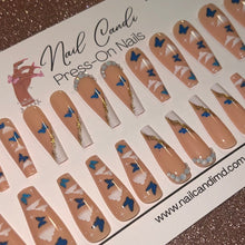 Load image into Gallery viewer, Long nude nails with blue butterflies and white cloud design
