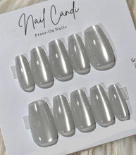 Load image into Gallery viewer, Silver press-on nails on a 'Nail Candi' branded card.
