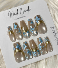 Load image into Gallery viewer, Set of press-on nails with floral designs on a 'Nail Candi' card.
