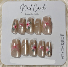 Load image into Gallery viewer, Set of press-on nails with floral designs on a 'Nail Candi' branded card.
