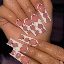 Load image into Gallery viewer, Extra long tapered square nails with white bow accent on middle finger and rhinestones
