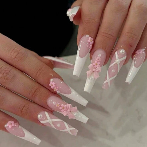 long french pink coquette nails coffin with lots of detail and charms