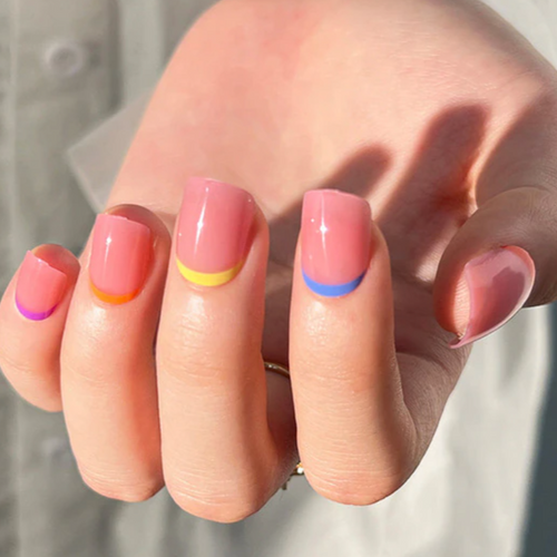 Short light pink nails with multi-color line design around the cuticle