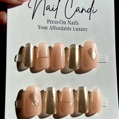 Short coffin gel nails in a sheer nude color with gold chrome accents. 