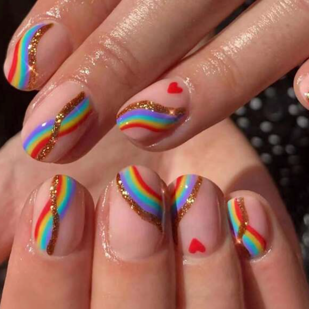 short press on nails with rainbow design and heart accents