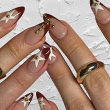 Load image into Gallery viewer, medium almond burgundy french nails with star design and gold studs
