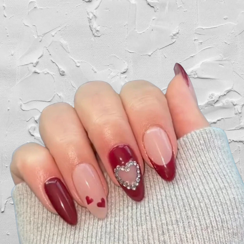 Medium Almond Red and nude nails with cutout heart and rhinestones
