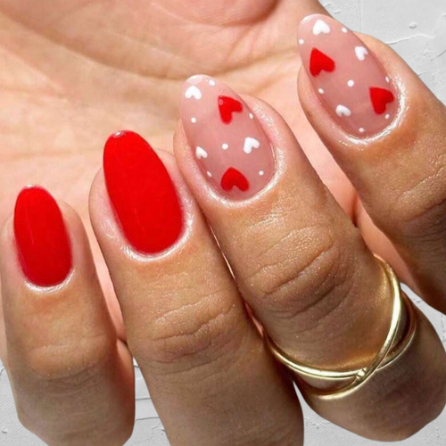 medium length almond shape nails with red heart designs. 