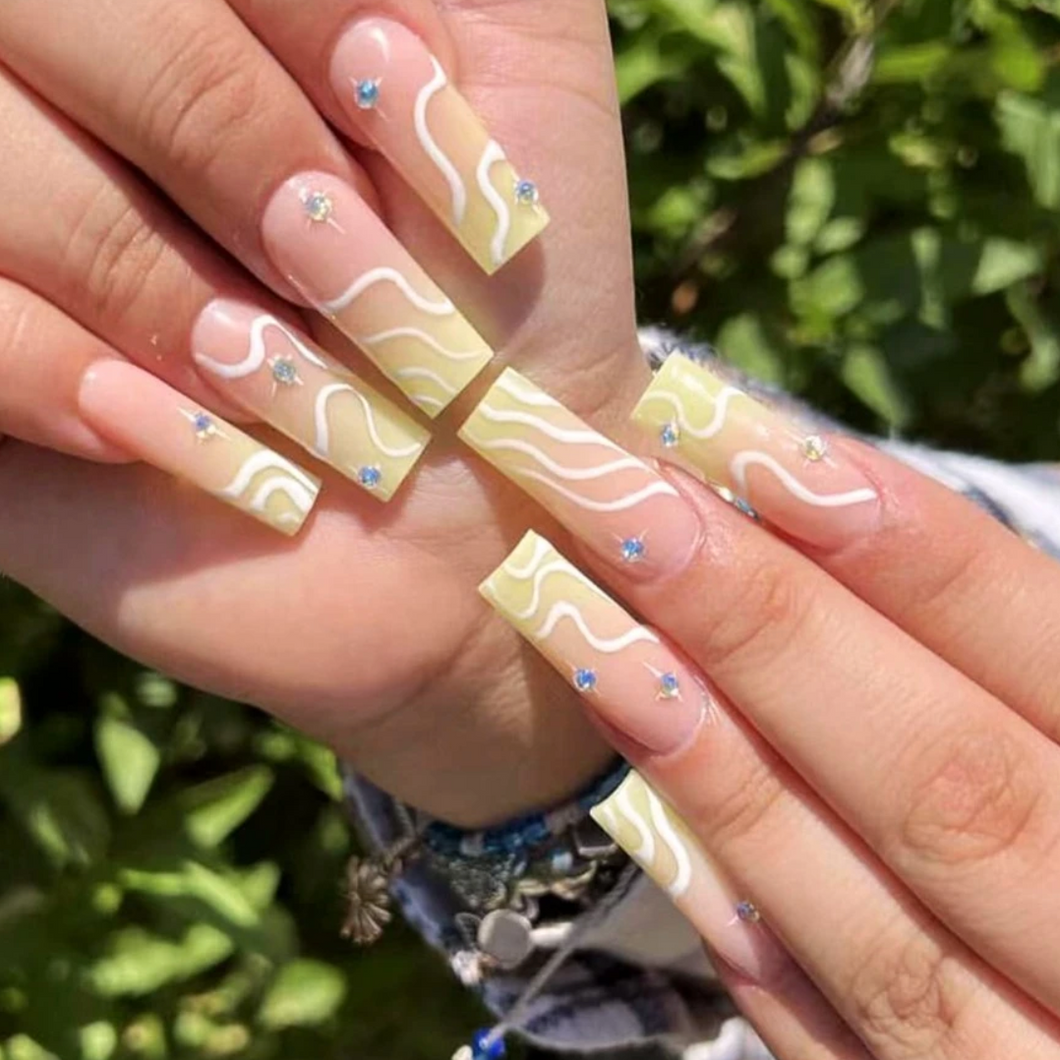 Jackie's XL square pale yellow nails are the perfect statement for summer, adding a pop of color to any outfit. With their eye-catching hue and sleek shape, these yellow acrylic nails are sure to turn heads and make a bold fashion statement.