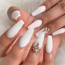 Load image into Gallery viewer, Long matte white tapered coffin shape nails with gold rhinestone design accent nails.
