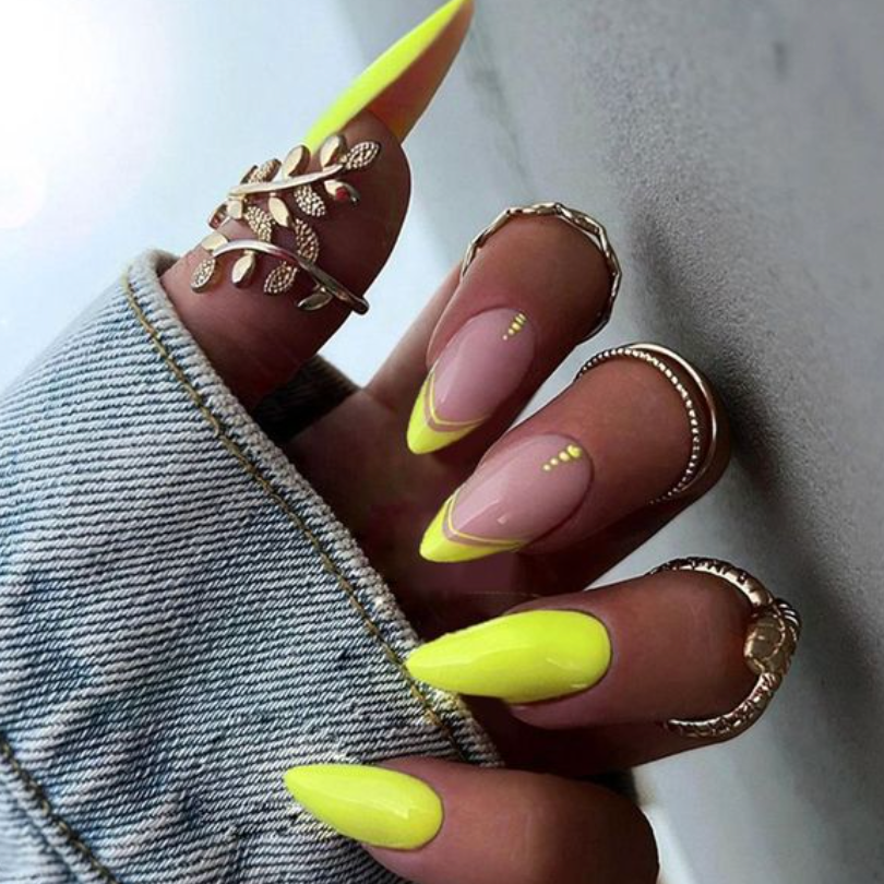 Long stiletto nails neon yellow press ons with yellow dot accents near cuticle