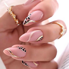 Load image into Gallery viewer, Medium length almond shape press on nails with nude base and gold swirls with black and nude leopard print design
