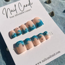 Load image into Gallery viewer, short square press on nails with blue ocean wave design and black bird accents
