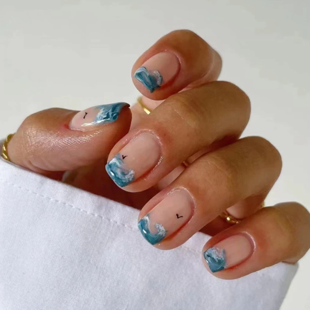 Short square nails with blue wave and bird design. 