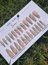Load image into Gallery viewer, Long Nude coffin nails with teal and gold swirls with a matte finish. 
